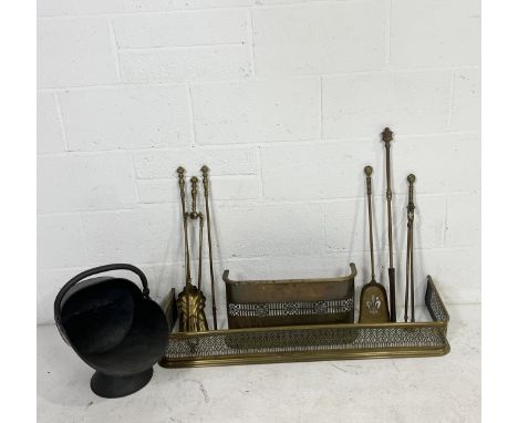 A brass fireside companion set including poker, tongs, fender, metal scuttle etc