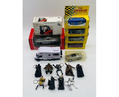 A small collection of boxed die-cast vehicles including a Burago Mercedes-Benz 300SL car, Linde Forklift, four Maisto Superca