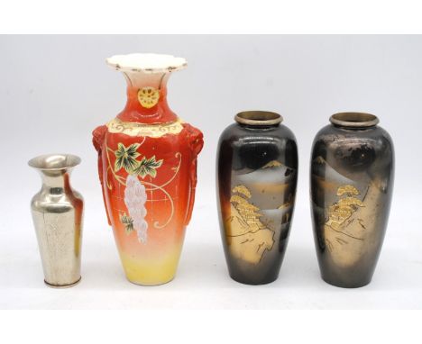 An Oriental ceramic Satsuma vase with character marks to base, along with a pair of brass vases depicting mountainous scenes 