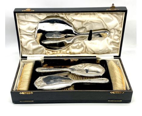 A cased hallmarked silver dressing table set consisting of mirror, four brushes and a frame for comb, box tatty