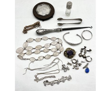 A collection of various jewellery (mainly silver) along with silver tongs, silver topped bottle, button hook and "The Silver 