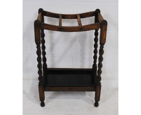 An antique oak stick stand, with barley-twist supports 