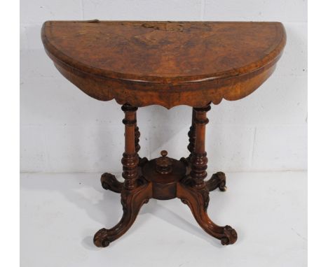 A Victorian walnut veneered demi-lune folding card table, with green baize inset and carved detailing - top A/F