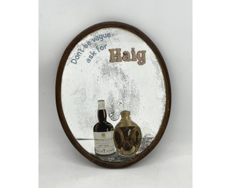 A vintage oval advertising mirror for Haig Whiskey "Don't be vague ask for Haig" - length 40cm 