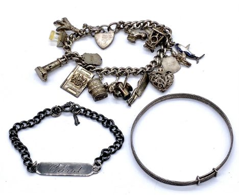 A vintage silver charm bracelet with assorted charms, a silver identity bracelet and a silver bangle, total weight 83.4g