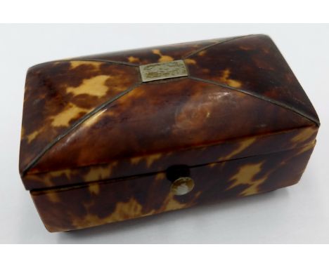 An antique tortoiseshell trinket box with blue glass ball feet, and red silk lining, 6cm wide, 3cm deep, 3cm high.