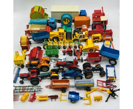 A collection of toy farming machinery including tractors, hay balers, dung spreaders, combine harvester, ploughs, horsebox, t