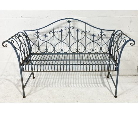 A modern wrought metal garden bench with scrolled arms 
