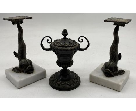 A pair of antique stylised dolphin finials mounted on marble along with an antique bronze pomander in the form of an urn, dol