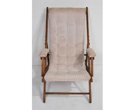 A vintage upholstered folding armchair, with button-back upholstery