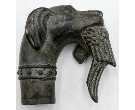 A vintage bronze cane handle in the form of dog with a bird in its mouth, 6.5cm high, 6.5cm.