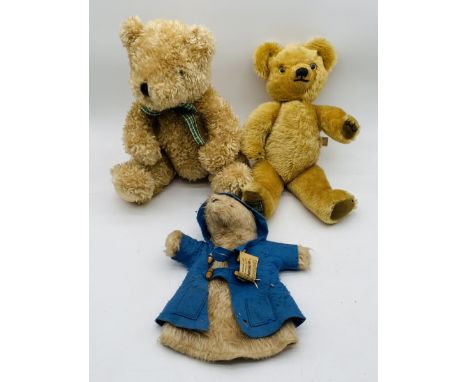 A Merrythought teddy bear, made exclusively for Harrods, along with House of Fraser 1997 teddy bear and Paddington Bear glove