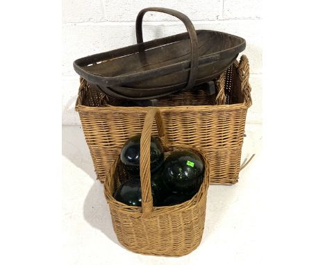 Three wicker baskets along with a vintage trug and six green glass fishing floats