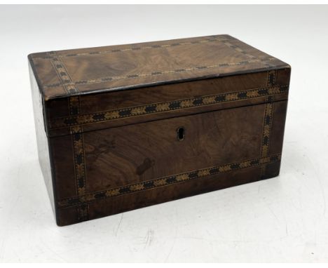 A Victorian walnut twin compartment tea caddy with bands of Tunbridge style decoration 