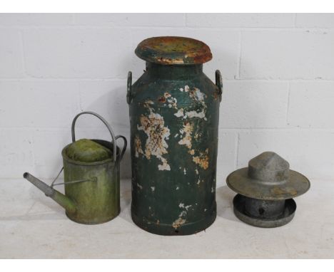 A weathered painted milk churn, along with a galvanised watering can and a chicken feeder