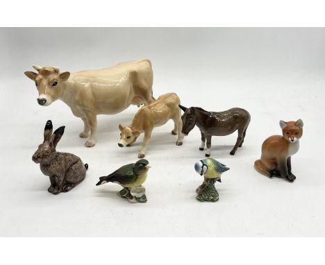 A collection of various ceramic animals including Beswick donkey, large Melba Jersey cow, Beswick birds etc.