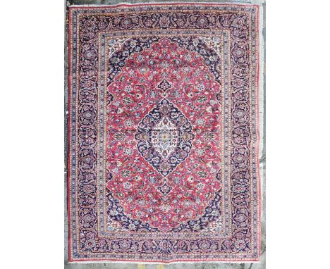 Carpet, hand knotted Persian with triple medallions within scrolling foliate spandrels and multiple borders. H.321 W.218cm. 