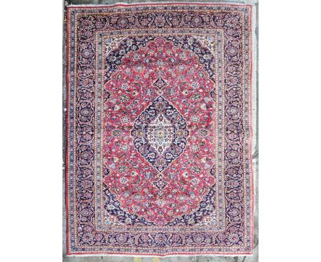 Carpet, hand knotted Persian with triple medallions within scrolling foliate spandrels and multiple borders. H.321 W.218cm. 