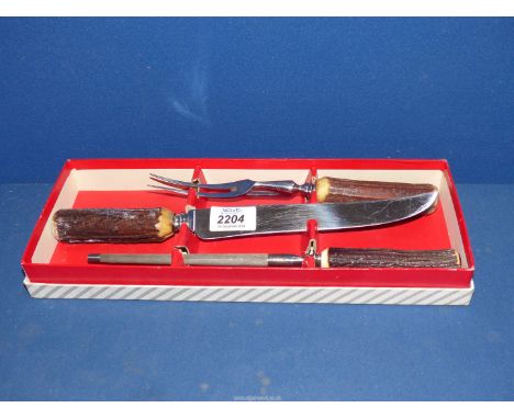 A boxed, antler handled Carving set including knife, fork and steel.
