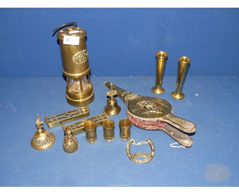 A selection of brass items to include: bellows, small trench art vases and a brass miners lamp.