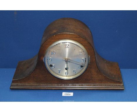 A darkwood cased Westminster chiming Napoleon mantle Clock having Arabic numerals, pendulum and key.
