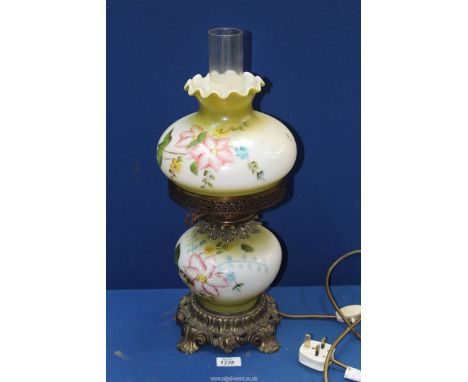 A Glass Oil lamp with white - green base and shade with painted flowers and clear chimney.