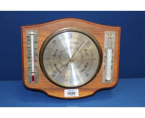 A Comitti of London Aneroid Barometer with thermometer and storm glass indicator mounted in mahogany.