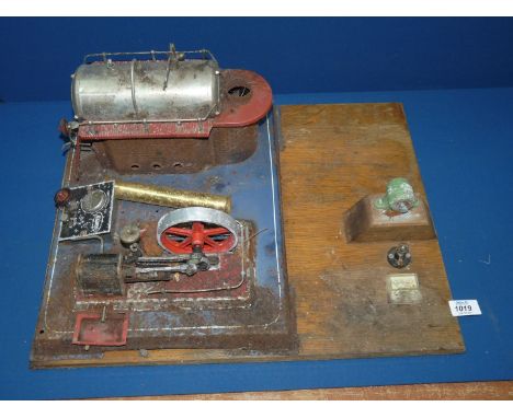 A Wilesco live steam stationary engine having a double-acting cylinder of approximately 15 mm stroke driving a 10 cms diamete