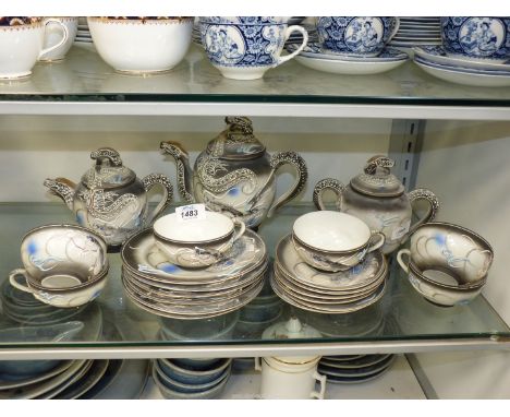A 'Y.Y. China' six setting tea set depicting dragons on a stormy grey ground, sucrier a/f. dragon head spout and finials on t