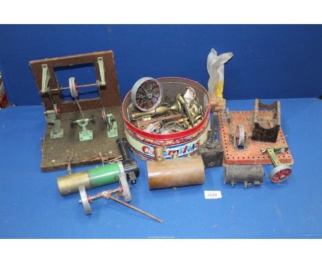 A box of model live steam engine components including a base and an upright wall-fixed drive shaft with a "belt-driven" doubl