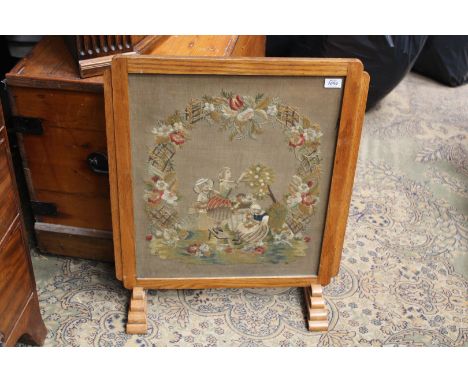 A Firescreen with woolwork tapestry picture of young girls gathering flowers, 23 1/2" x 29".