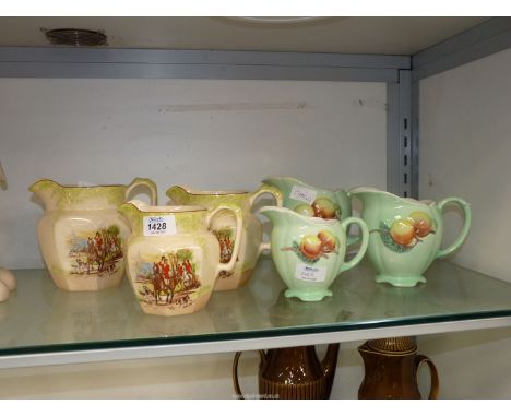 Two sets of three graduated jugs;  Royal Winton and Price Bros.