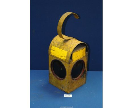 A vintage yellow road lamp and burner.