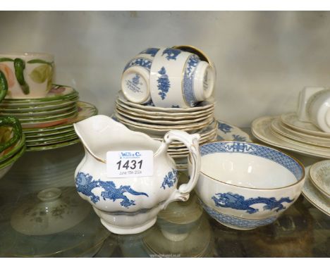 A Booths blue and white 'Dragon' part tea set to include; 6 saucers, 6 tea plates, 4 cups, milk jug, sugar bowl and cake plat