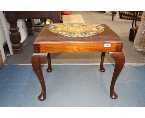A rectangular Mahogany framed Stool standing on cabriole legs, the drop-in tapestry seat depicting stylised flowers and folia