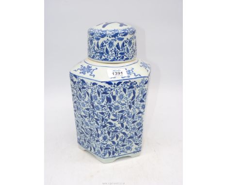 A large Chinse blue and white tea canister with blue foliate and calligraphy reserve.
