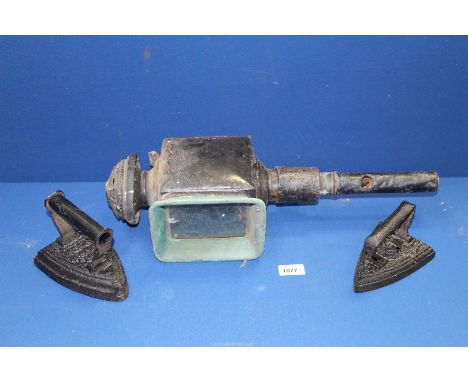 A carriage Lamp having old conversion to electric and two flat irons.