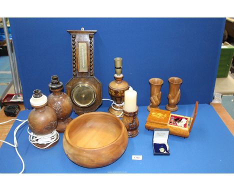 A quantity of treen including carved table lamps, salad bowl, barometer, pair of 'Hand' goblets, musical jewellery box etc.