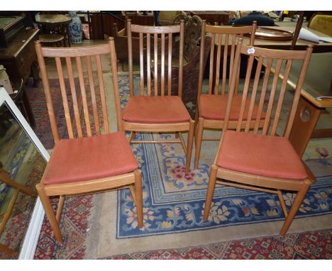 A set of four Ercol Windsor light Elm framed Dining Chairs having rust coloured Velcro- attached pad cushions.