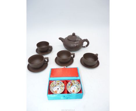 A Chinese unglazed teapot scratch decoration plus four matching cups and saucers, seal mark to base, plus a pair of porcelain