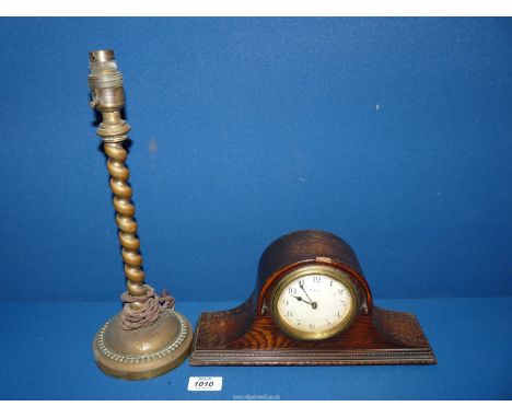 An eight day Clock and a Brass lamp base.