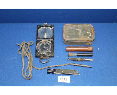 A WWII compass Magnetic Marching Mark 1, along with a green tin containing gun cleaning kit complete with a military L1A1 SLR