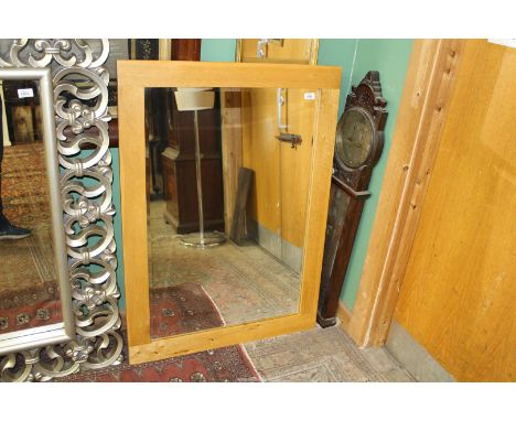A light Oak rectangular framed bevelled mirror, 31" x 43".