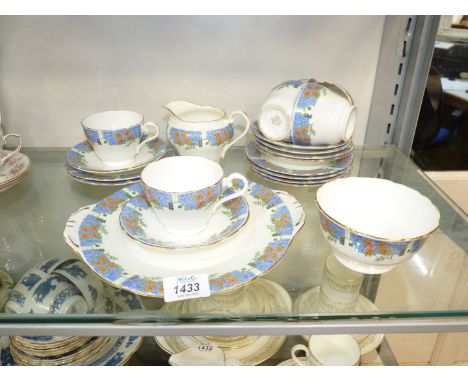An Aynsley part tea set, white ground having blue panels decorated with orange flowers, to include; 6 cups, saucers and tea p