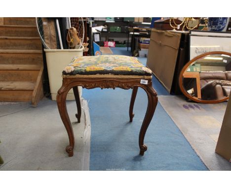 A nicely carved oak stool standing on cabriole legs terminating in scroll feet and having shell and scroll decoration through