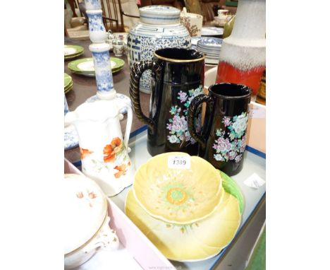 A Carltonware, Austrian Design, yellow floral bowl and saucer, a white ground Jug with poppy design and two black pottery, fl