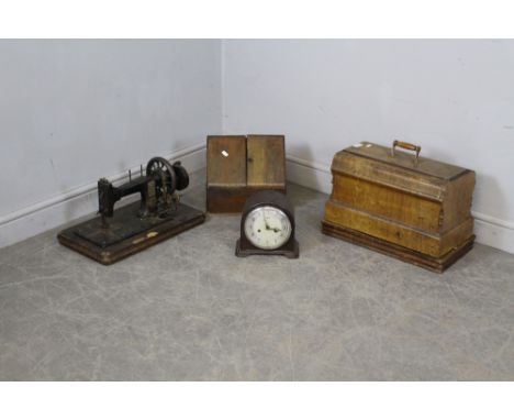 An antique German sewing machine, a walnut cased sewing machine, a smiths mantel clock and a stationary box