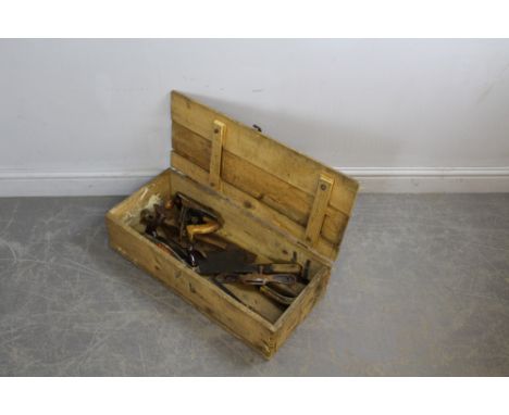 A slatted pine box containing various vintage tools, including spoke shaves, Surform rasp, cleavers. 16cm x 67cm x 29cm