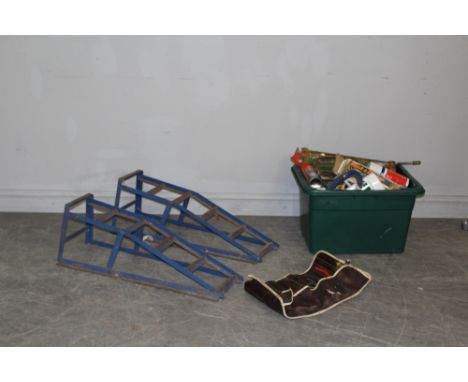 A pair of blue painted GLT international car ramps and a box of various tools