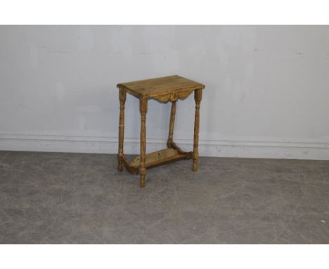 A small pine occasional table with turned supports and book trough under-tier 59.5cm x 45cm x 30cm